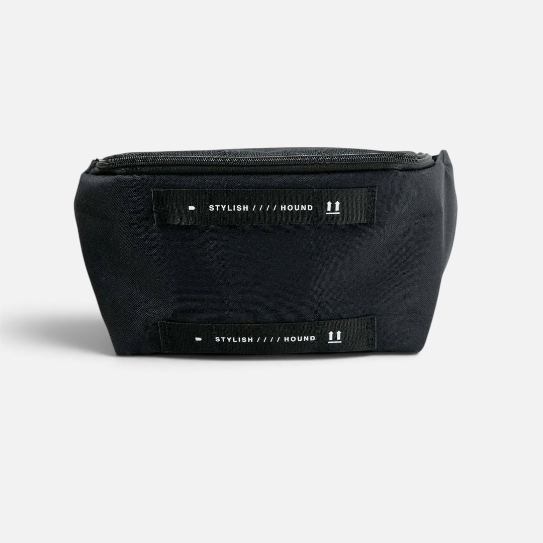 The Dog Emporium black canvas waist and cross body bag featuring white logo straps and durable zippered pockets.