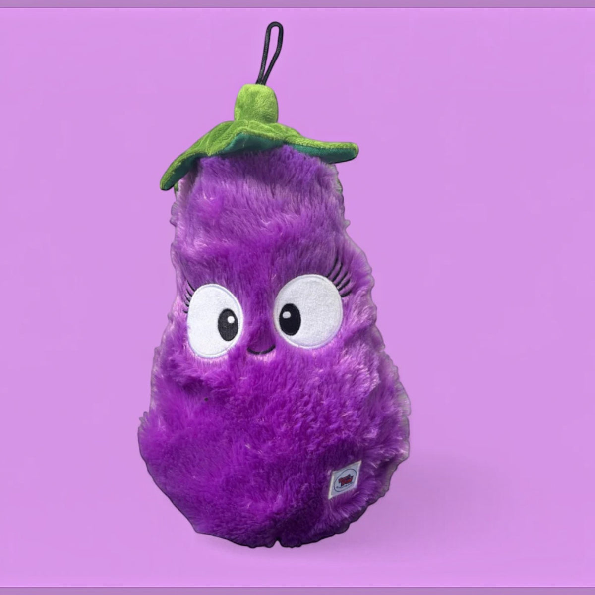 Eggplant plush dog toy made from 100% recycled material