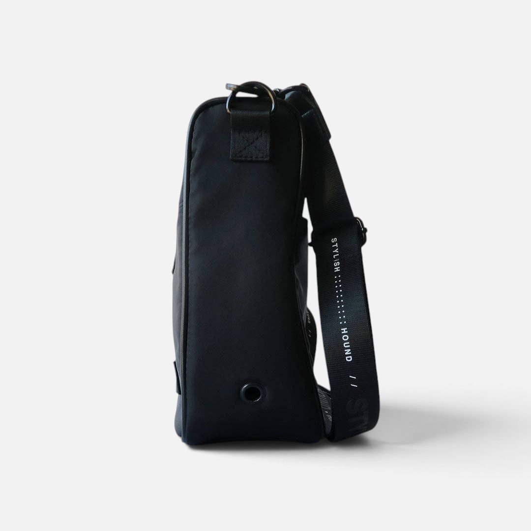 The Dog Emporium Day Tripper bag in black canvas with adjustable branded strap and side eyelet for poop bags
