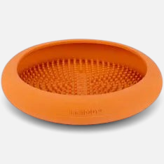 The Dog Emporium LickiMat UFO orange rubber feeding mat with textured soother nubs for pet treats and distraction.
