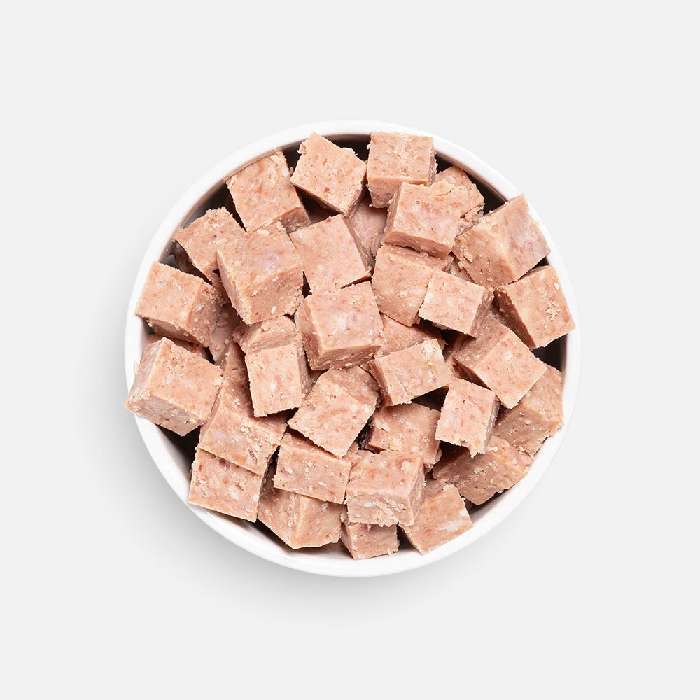 The Dog Emporium SPD Fresh Roll chicken and brown rice dog food cubes served in a white bowl