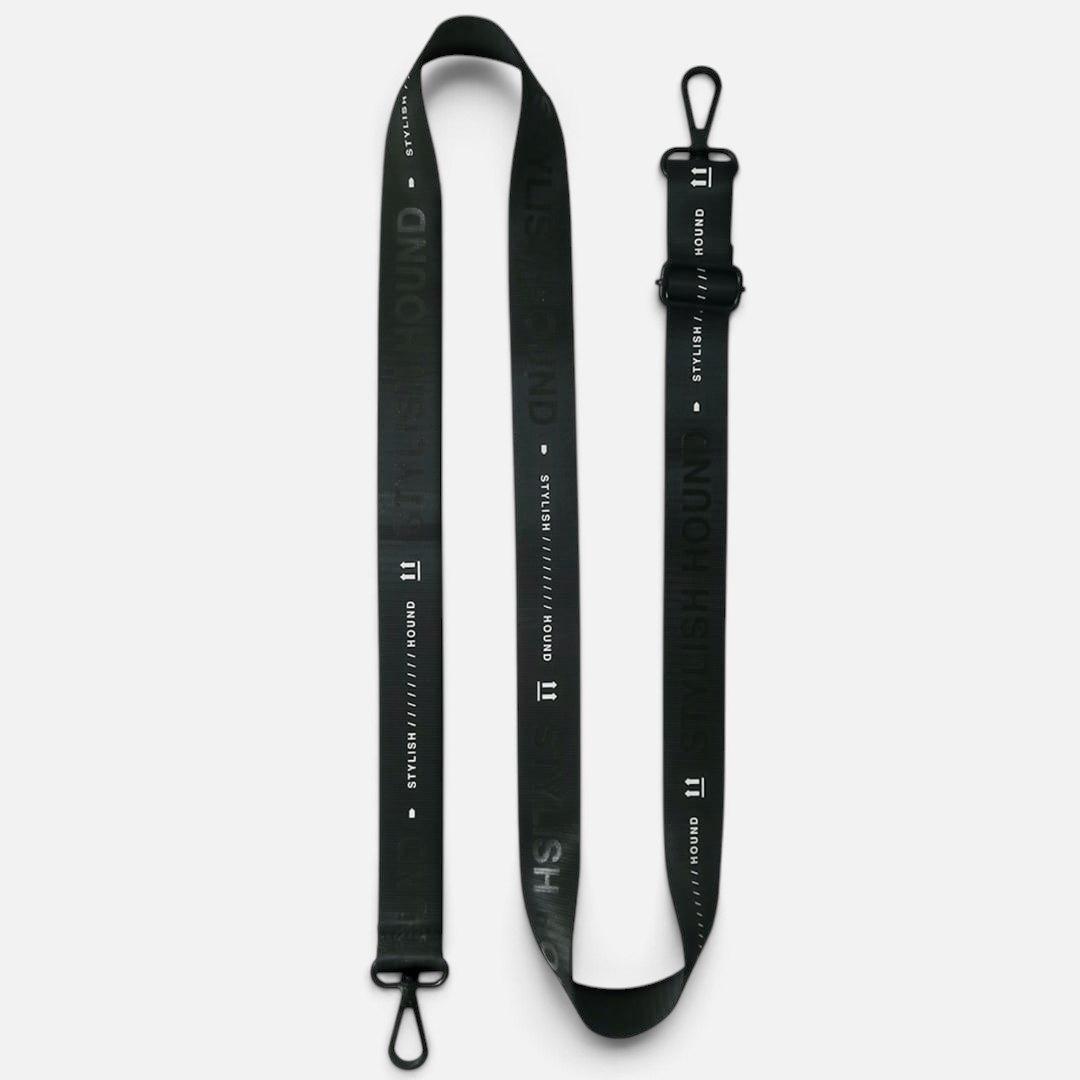 The Dog Emporium black adjustable dog walking bag strap with white logo branding and durable black hardware.