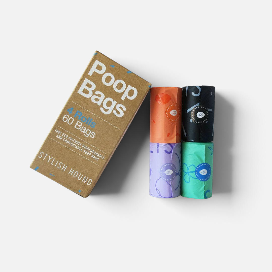 The Dog Emporium biodegradable poop bag set with four colourful rolls and a cardboard box on a white background